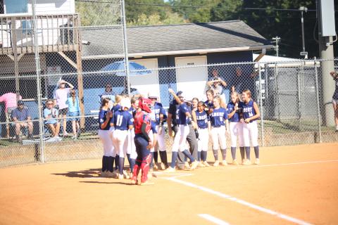 Kamryn Webb (26) crosses the plate and celebrates with teammates after hitting a home run in Elbert’s 15-0 win over Putnam County on Oct. 15. (Photo by Bo Underwood)
