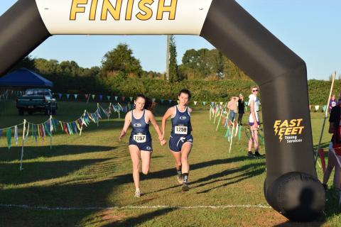 Marley Geyer (left) and Kennedy Ray finish side-by-side at the Jan Taylor Invite at Franklin County High School on Oct. 16. (Photo courtesy of Shane Scoggins / The Franklin County Citizen) 