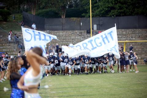 The Elbert County football team runs through the banner before their homecoming game against Oglethorpe on Sept. 19. (Photo by Bo Underwood)