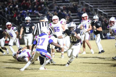 Petey Allen (30) stiff-arms a defender in Elbert’s 24-7 playoff win over Oglethorpe on Nov. 14. (Photo by Bo Underwood)