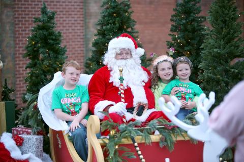 Children sit with Santa at Elberton's Candlelight Shop Night on Nov. 25. (Photo by Mark Wells)