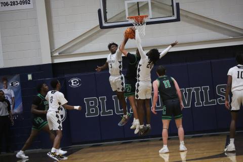 D.K. Winn (3) and Blu Hester (20) block a shot.  (Photo by Bo Underwood)