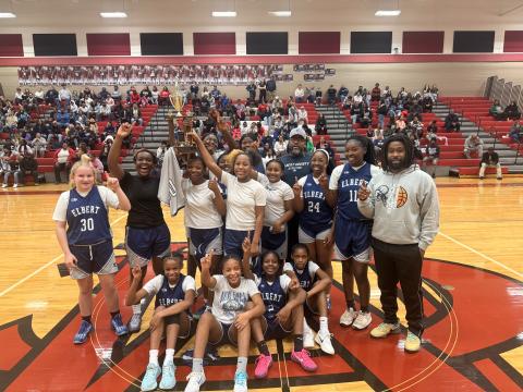 The Elbert County Middle School seventh grade girls’ basketball team celebrates after their win in the NEGIAA championship game. (Photo courtesy of Kathleen Newman)