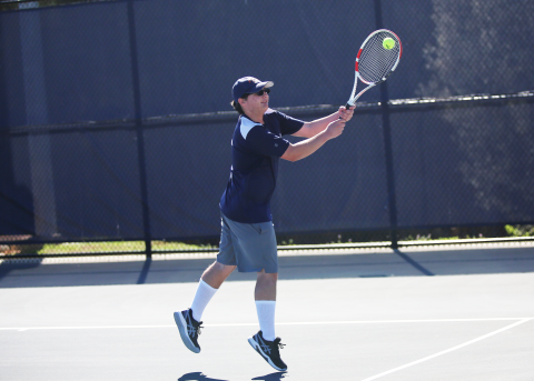 Adrian Jenkins returns a serve with two hands. (Photo by Bo Underwood)