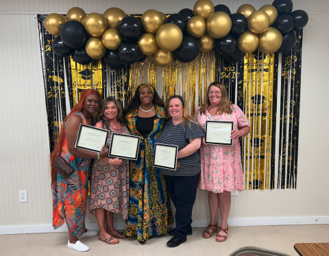 (L-R) Sandy Wingfield, Chrissy Fleming, Talyra Sims, Kelly Shea and Terri Jackson pose after a graduation ceremony for Sims' Mother to Mother Recovery Center, where Wingfield, Fleming, Shea and Jackson completed a 12-month course. (Photo by Mark Wells)