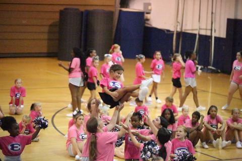 Ella Harrell is thrown through the air during cheer camp at Elbert County Comprehensive High School (ECCHS). A total of 82 future cheerleaders were in attendance for the camp put on by the ECCHS cheerleaders and coaches. (Photo by Bo Underwood)