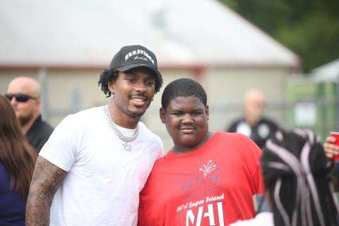 Mecole Hardman poses with a camper at last year's Friends Helping Friends Football Fun Day. (Photo by Mark Wells)