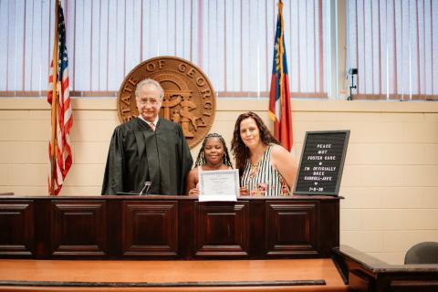 Judge Harvey Wasserman, Bree Carroll-Jave and Victoria Carroll-Jave pose for a picture in the courtroom on Bree’s adoption day. (Photo courtesy of Victoria Carroll-Jave)