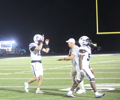 Quarterback Brody Baker and head coach Andy Dyer high-five following Elbert’s win over East Jackson. (Photo by Bo Underwood)