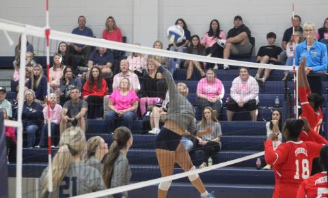 Melanie Badillo skies at the net to give Elbert County an 11-4 lead in the second set of their series with Therrell.
