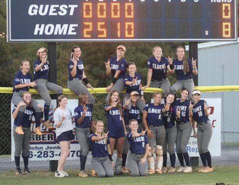 Lady Devils players pose in front of the scoreboard after shutting out Callaway to advance to the second round of state.