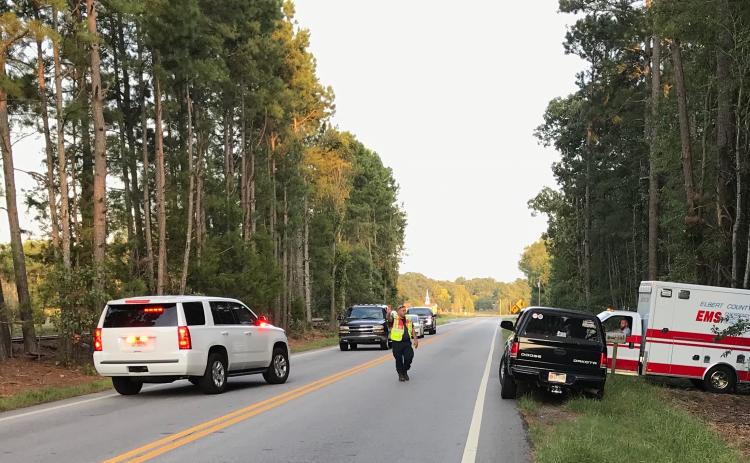 Elbert County personnel remove the body of a 51-year-old woman from a Bowman Highway residence early Sunday evening. (Photo by Jones)