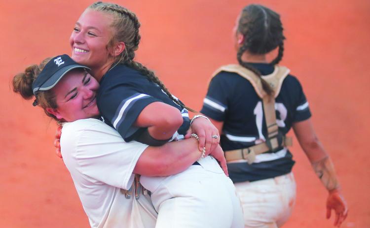 Lady Blue Devil assistant coach Katie Archer (left) and senior pitcher Lauren Hart react during Elbert County’s 11-1 victory at Clarke Central High School  Sept. 4 in Athens (Photo by Cary Best)