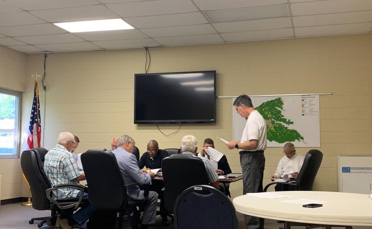 Phil Pitts announces the proposed mill rates to the Elbert County Board of Commissioners. (Photo by Rose Scoggins)
