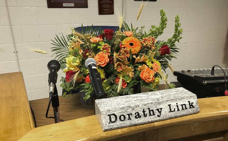 Dorathy Link, an Elbert County School District Secretary, died in an accident last week in Hartwell. The school board paid tribute to Link Monday night at its regular meeting by placing flowers at the podium where she normally sits during school meetings. (Photo by Jones)