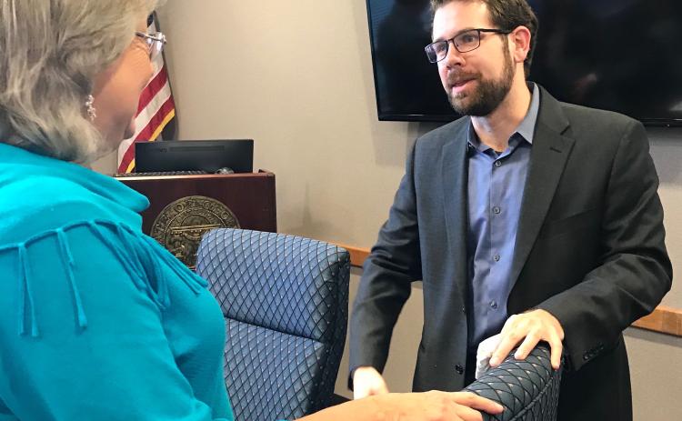 Daniel Dobbins (right), hired unanimously by the development authority Thursday, talks with authority member Leona Brown. (Photos by Jones)