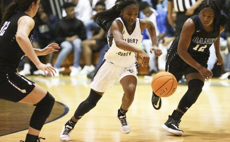 Lady Blue Devil freshman Terrace Hester (center) splits two Lady Leopard defenders during Elbert County’s 51-44 win over Banks County Jan. 24 in Elberton. (Photo by Dan Giles)