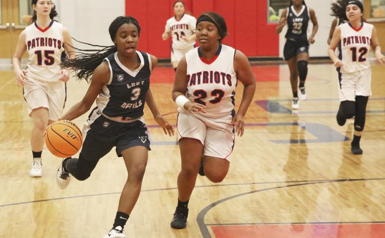 Lady Blue Devil freshman (left) drives to the basket during Elbert County’s 49-15 win at Oglethorpe High School Jan. 17 in Lexington. (Photo by Dan Giles)