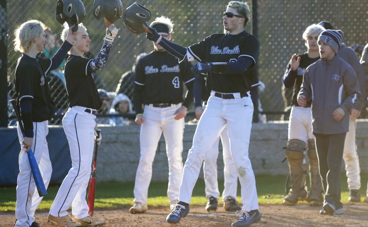 Diamond Devils (L-R) Jordan Mills and Ian Warwick tip their hats to junior Carter Dye for hitting his second of three home runs during Elbert County’s region doubleheader sweep of Oglethorpe County March 6 in Elberton. (Photo by Cary Best)