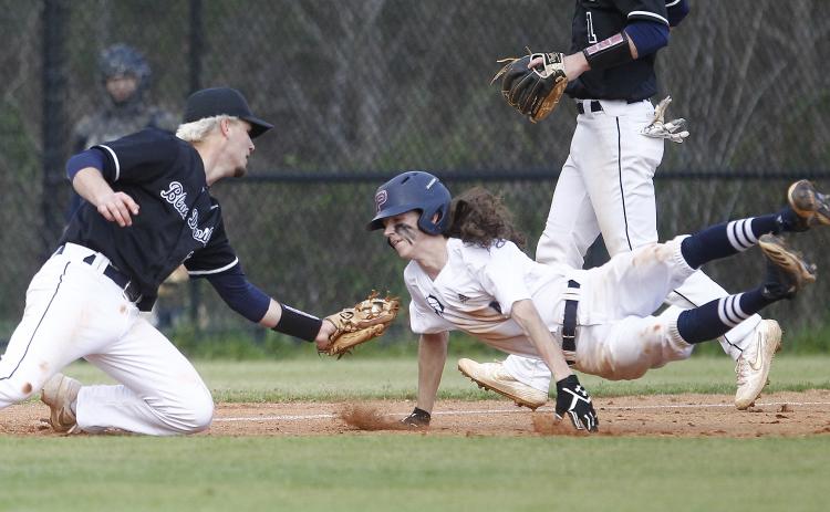 Diamond Devil senior Carson Pullen tags senior War Eagle Jeremy Humphries in the third inning of Elbert County’s 8-7 region win at Putnam County March 13 in Eatonton. (Photo by Cary Best)