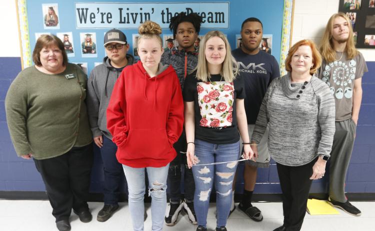 Mountain Education Center offers ‘a lot more support here;’ Shown are (L-R) Mountain Ed Administrator Laura Lynch, Emmanuel Kim, Faith Carey, Miles Plummer, Emma Smith, Brandon Heard, Mountain Ed Administrator Renee Padgett and Seth Adams. (Photo by Scoggins)