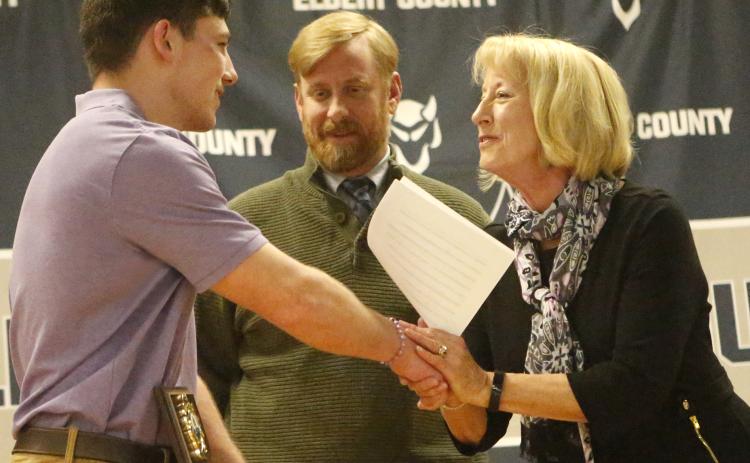Senior Gavin Brady (left) accepts the Kyle D. Wilhite Memorial Wrestling Award from Clint Wilhite and Connie Spivey during the Elbert County High School 2019-2020 Winter Sports Athletic Program March 9 in the middle school auditorium. (Photo by Cary Best)