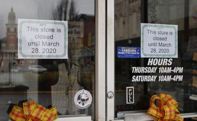 C&M Thrift Store posted signs on their doors to let customers know they would be closed until March 28. (Photo by Scoggins)