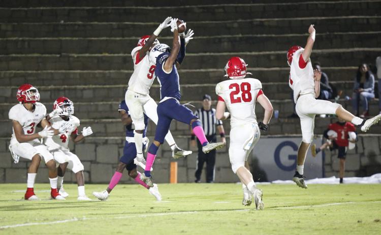 Christian Harris (above) latches on to a Braydon Scarborough pass as the clock runs out in Friday night’s 27-20 loss to Lincoln County in the Granite Bowl. (Photo by Scoggins)
