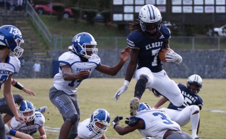 Q.T. Teasley leaps over a defender Saturday in the Granite Bowl. Playing in his final game in the Historic Granite Bowl, Teasley caught two passes for 41 yards against Bremen in the state playoffs.  (Photo by Scoggins)