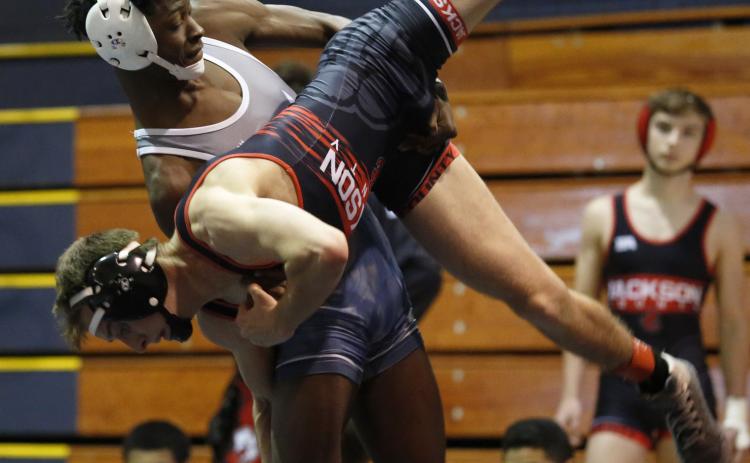 Senior Jamal Rucker takes down his opponent from Jackson County during the Granite City Scramble in the Inferno Dec. 12. (Photo by Scoggins)