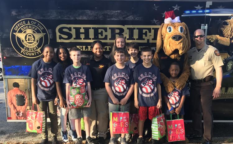 Elbert County Sheriff’s Office Lt. Marc Fleming, shown at the far right prior to a Christmas parade in Elberton, said his work as a school resource officer was the “best way to make a difference in the community.’ That ended Wednesday when the 14-year law enforcement veteran received a one-day notice by certified mail that Sheriff Melvin Andrews was firing him.