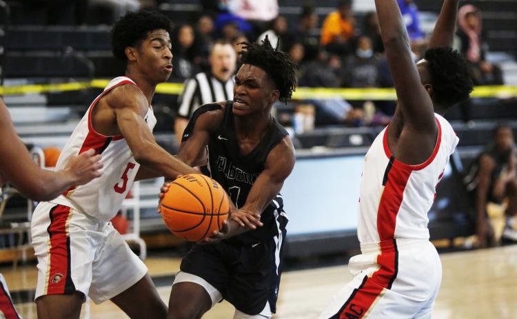 Jaelin Webb attempts to make a pass in heavy traffic in the McDonald’s Shootout Tournament at Hart County High School in Hartwell Monday. (Photo by Scoggins)