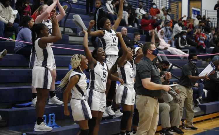 Sophomores (L-R) Lilly Ray, Terrace Hester, Niya Moon, junior Jordan Glaze, sophomores Brenasia Faust and Aaniyah Allen and Head Coach Josh Jones react to a score from senior Jedihah Williams in the Lady Devils’ competition against Union County during the Region 8-AA Tournament at Banks County Friday, Feb. 12. (Photo by Scoggins)