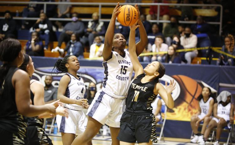 Lady Devil Jameria Allen watches as Jordan Glaze attempts to put up a shot against the Temple Lady Tigers during the first round of the GHSA state playoffs in the Inferno Tuesday, Feb. 23. By defeating the Lady Tigers 52-14, the Lady Devils advanced to the Sweet Sixteen, where they defeated South Atlanta 62-28 Friday, Feb. 26. (Photo by Scoggins)