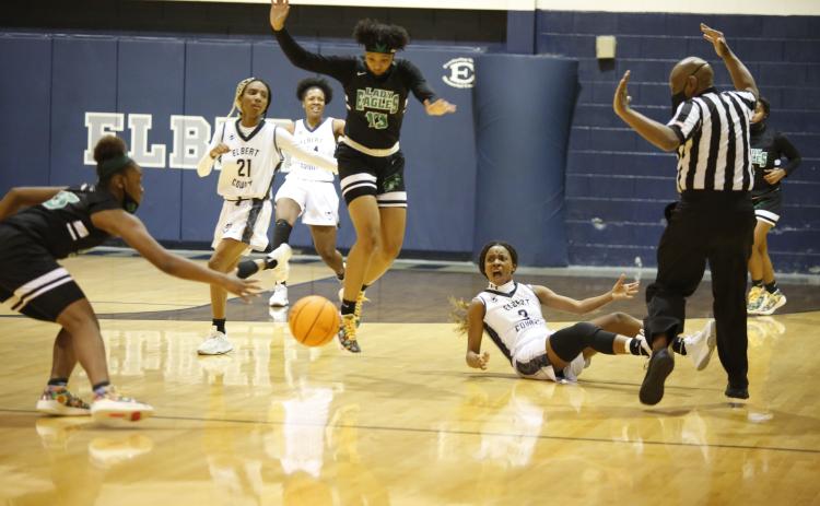 Niya Moon (21), Jamia Allen and Aaniyah Allen (3) react after Aaniyah was knocked to the ground by a referee during Tuesday’s 46-45 loss against Josey in the playoffs. (Photo by Scoggins)