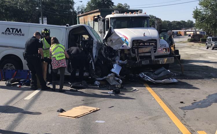 College Avenue, the main artery through Elberton on the west side of town, was closed to all traffic during most of the morning on Wednesday, June 16. Authorities still aren’t sure why the reinforced “ATM Response” van on the left crossed from the eastbound lanes of College Avenue turning lane,  through the turning lane and into the westbound side. Three men  were transported to hospitals after the accident. (Photo by Jones)