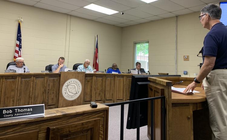 Elbert County Chief Financial Officer Phil Pitts (right) talks about the 2021-2022 budget in front of the Elbert County Board of Commissioners Monday afternoon. The commission approved the budget, which includes a $1.2 million increase, with over half for raises within the county government. (Photo by Scoggins)