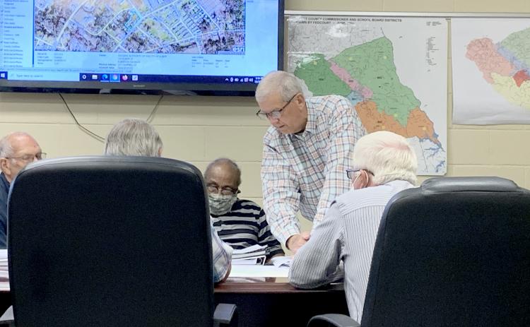 County Administrator Bob Thomas (center) shows the Elbert County Board of Commissioners the first draft of a map that would redraw the county’s districts during the BOC’s work session Thursday, Oct. 7. The county is expected to vote on whether or not to redistrict the county by Nov. 2. (Photo by Scoggins)
