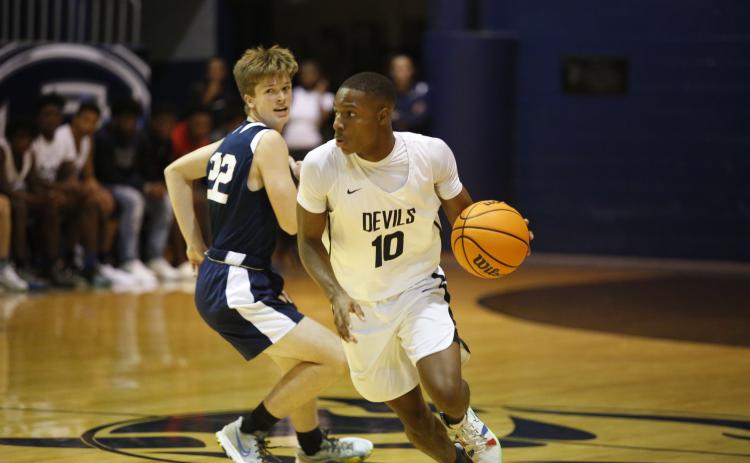 Senior Jamil Burton, pictured above during Thursday’s scrimmage against West Oak, will lead the Blue Devils this year. The Devils, along with Coach Don Hurlburt, are looking to defend the region championship title the team took home last season. (Photo by Scoggins)