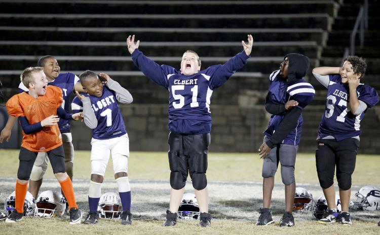 10U Elbert County Blue Devils (L-R) Chance Duck, Landon Newsome, JaMain Crosby, Justin Cleveland and Hayden Huff react to No. 51 Cole Freeman’s roar while being recognized during the community pep rally for the Elbert County Parks and Recreation teams Thursday, Nov. 18 in the Granite Bowl. (Photo by Scoggins)