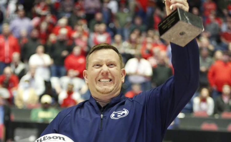 Lady Devils Head Coach Josh Jones holds up the GHSA State Championship trophy to the Elbert County crowd after defeating Rabun County 52-44 to bring home the program’s first-ever state title. Jones has been the Lady Devils’ head coach for the last four years after being named to the position in 2018. Before being head coach, Jones served as an assistant at the high school under Alton Smith and Wes Greer. (Photo by Scoggins)