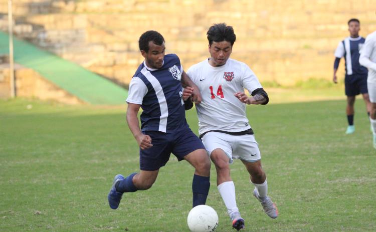 Jamaze Hall attempts to work the ball away from a Rabun County defender during the Devils’ 10-0 loss against Rabun County Friday, April 8. (Photo by Wells)
