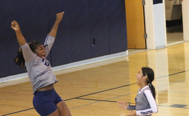 Jurnee Porter jumps for joy as Sophia Vargas laughs at Porter’s reaction during the Lady Rams’ win over Stephens County Middle School Aug. 31. (Photo by Wells)