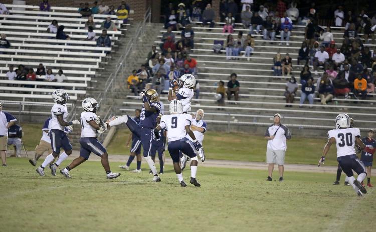 Sophomore Jermaine Sims (No. 3), senior DeCorius “Bubba” Heard (No. 31) and senior Keithshun Tate (No. 9) watch as senior Christian Harris (No. 11) intercepts a Warrior ball during Friday’s 21-3 win over Jefferson County High School. (Photo by Scoggins)