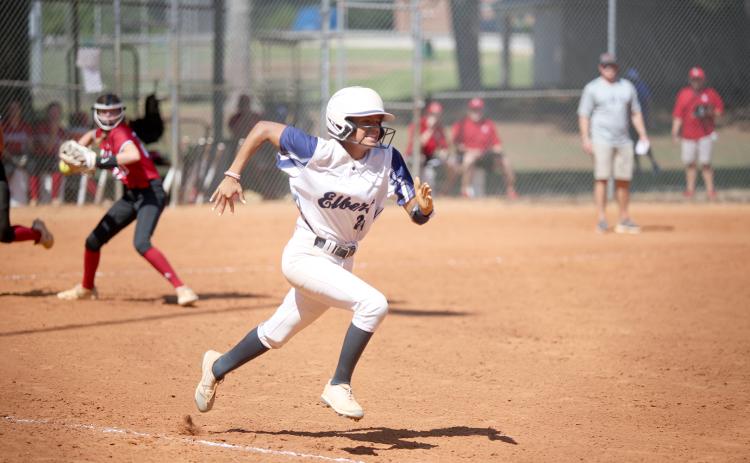 Lady Devil Carmen Burden sprints to first base as a Savannah Christian Lady Raider looks to throw her out during a tournament game in Winder Saturday, Aug. 27. (Photo by Scoggins)