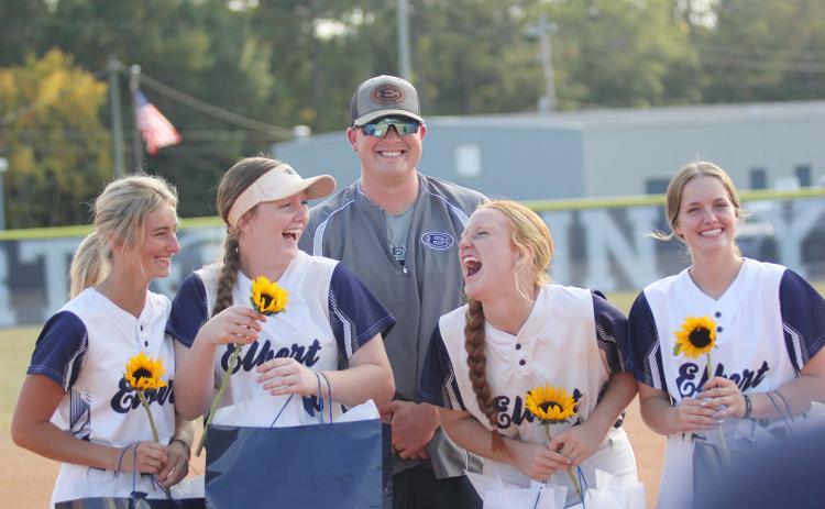 Lady Devil softball seniors (L-R) Jaynee Webb, Lilly Ray, Ava Lunsford and Emalise Andrews laugh during the senior recognition before the team’s final regular season home game Tuesday, Oct. 11. The four seniors were joined by Head Coach Drew Greer. (Photo by Wells)