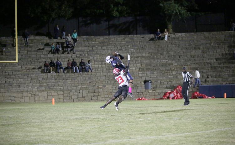 Senior Trustin Allen is rammed by a Rabun County Wildcat as he attempts to catch a pass during the Devils’ first loss of the season in the Granite Bowl Friday, Oct. 14. (Photo by Wells)