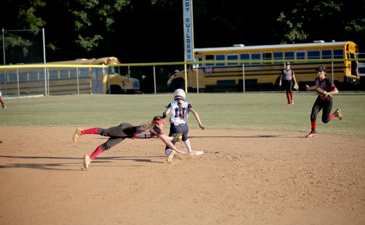 Hannah Brady safely slides past a Rabun County Lady Cat during the Devils’ 5-0 region win Oct. 4. The Lady Devils went on to secure the region championship after falling 4-0 to Commerce Oct. 6. (Photo by Wells)