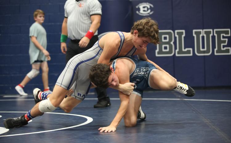 Eighth grader Rilee Rucker (gray) wrestles fellow eighth grade teammate Jackson Black (blue) during the Ram Invitational Saturday, Nov. 5 in the Inferno. The Rams kicked off their season with the home-opening invitational and placed first as a team. (Photo by Scoggins)