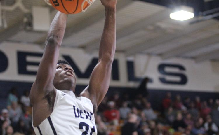 Senior Quan Moss makes a dunk during the Devils’ loss to Madison County Friday, Dec. 9 in the Inferno. (Photo by Wells)